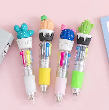 Cartoon character four colour press ballpoint pen with 0.7mm tip on a notepad.