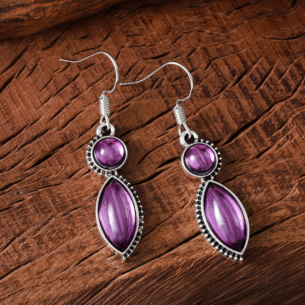 A pair of vintage geometric pendant earrings in black and purple with a Bohemian style.