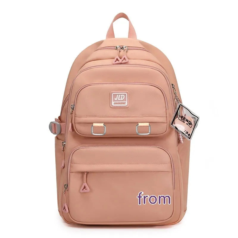 Girls' large capacity nylon school backpack in purple, shown with breathable back and anti-theft features.