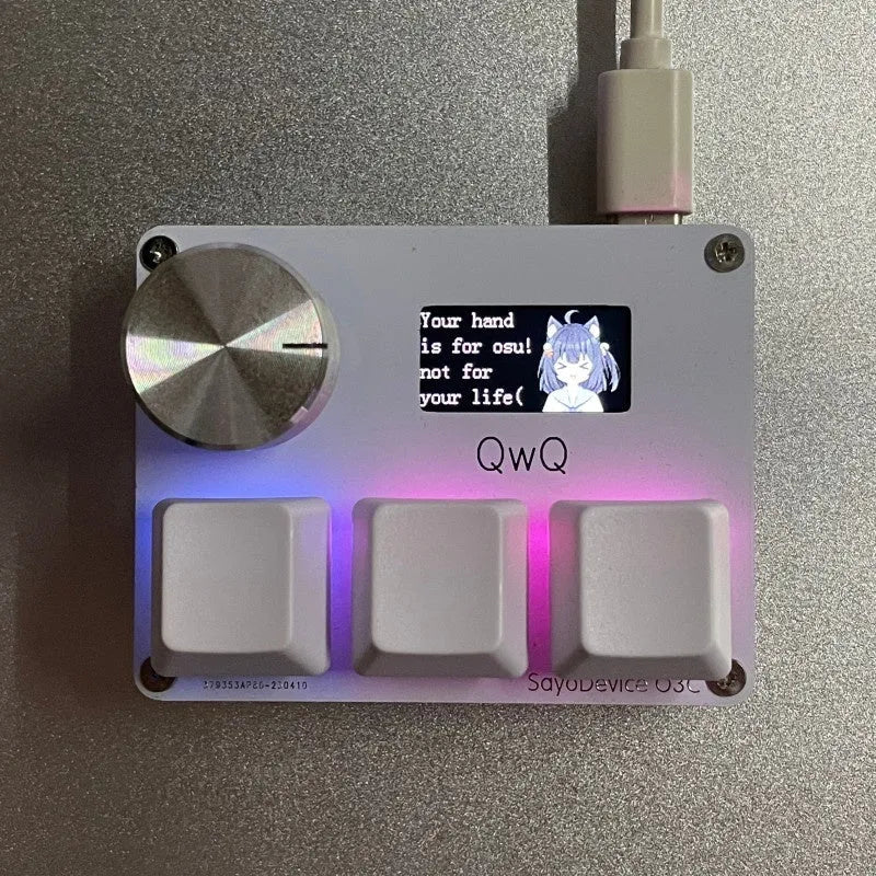 Magnetic axis gaming numeric keypad with colour screen, control knob, and RGB backlighting on a desk.