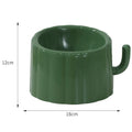 Dark green cat bowl with cactus design and anti-slip base on a wooden surface.