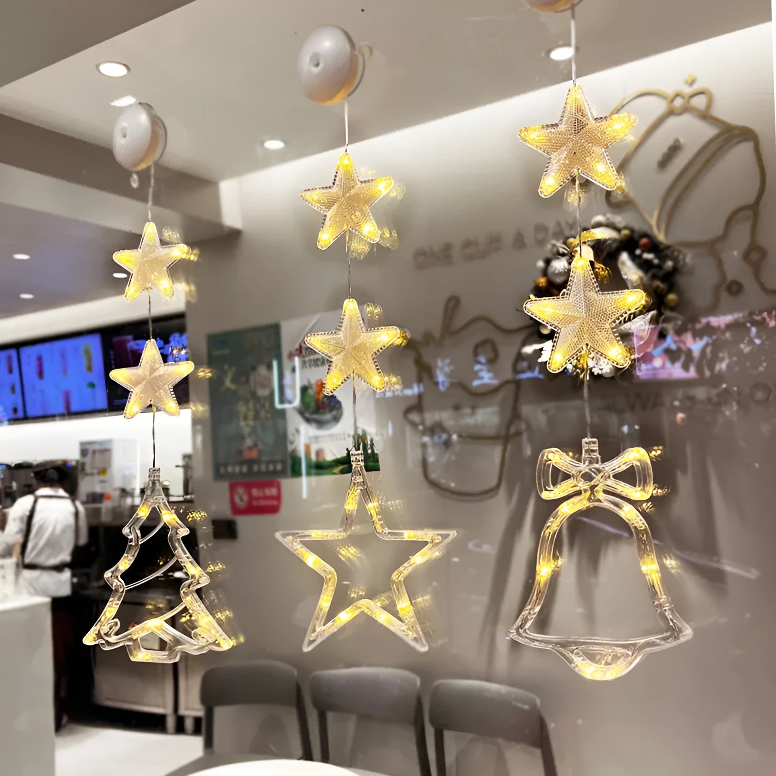 Set of three battery-powered LED Christmas pendant lights with suction cups, showing star, tree, and deer designs.