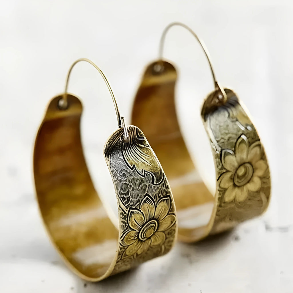 Gold electroplated alloy earrings with hollow geometric petal pattern design