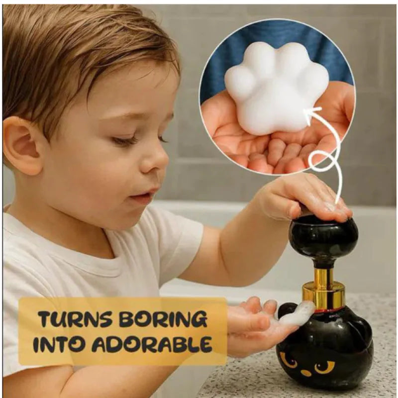 Black cartoon cat shaped plastic foam soap dispenser on a counter.