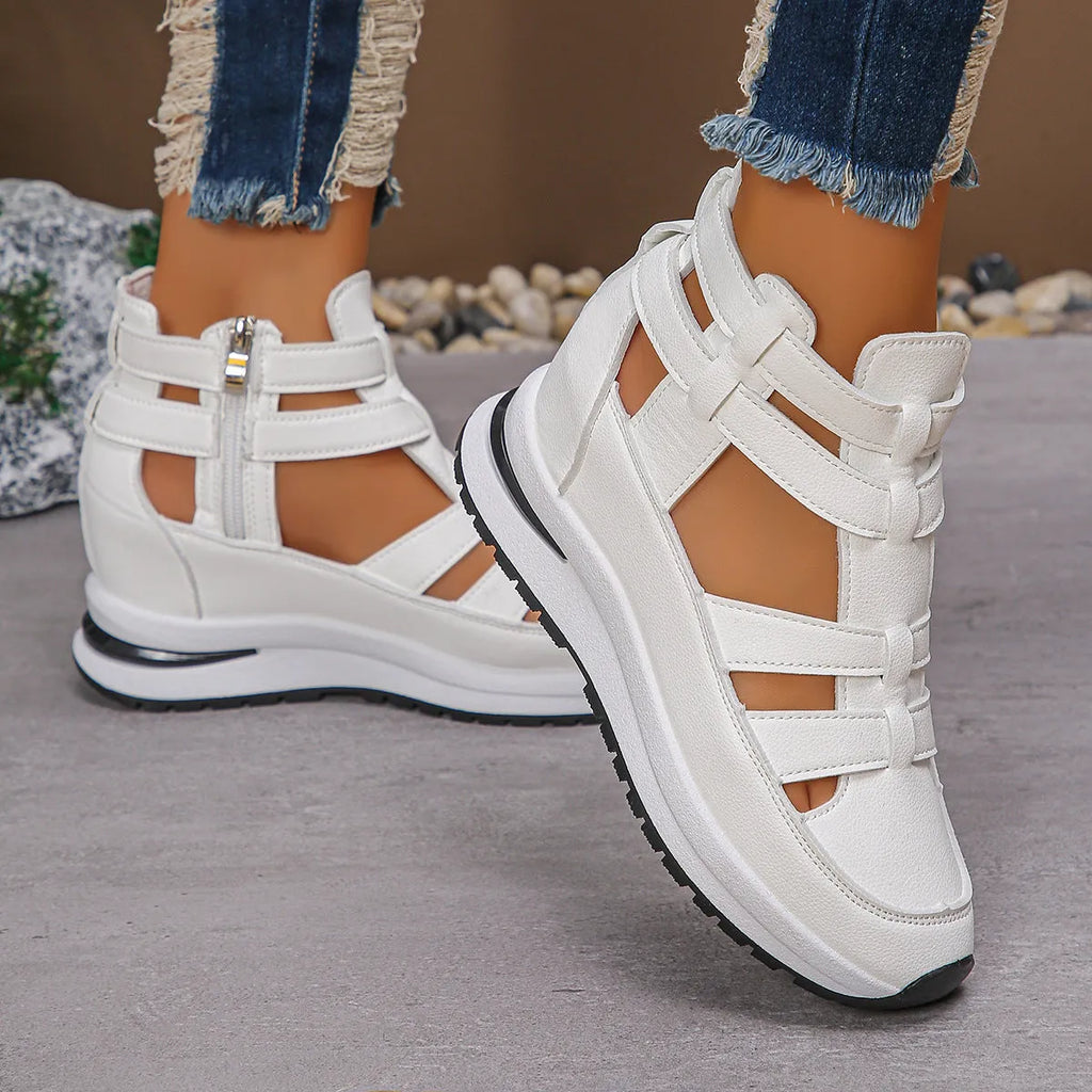Black women's close-toed platform sandals with hollow-out design and Velcro strap on a white background.
