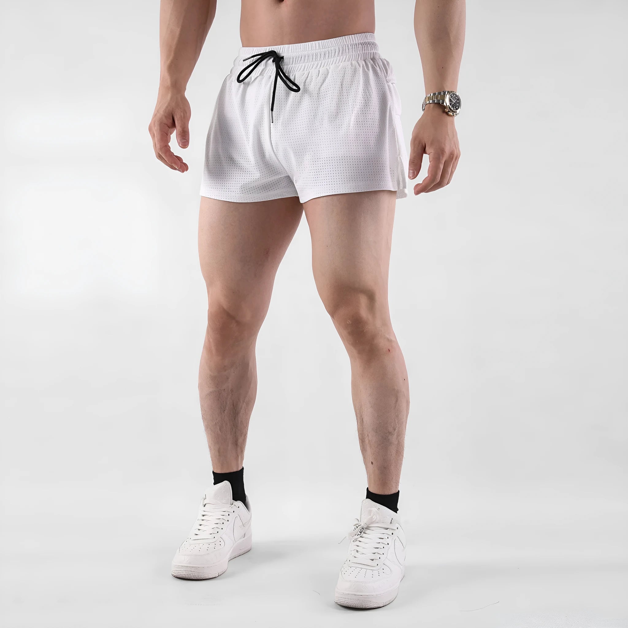 Man wearing black quick-dry nylon summer shorts with a mid-waist design.