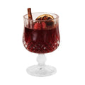 Clear glass wine goblet containing a scented candle with French mulled wine style