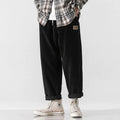 Men's loose straight corduroy sports trousers in army green colour on a hanger
