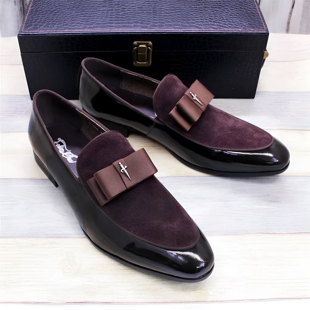 Men's black low-top leather brogue shoes with a patent leather finish and tassel detail on a rubber sole.