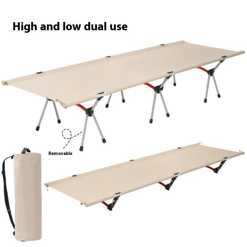 Lightweight portable folding bed set up outdoors in khaki colour with metal frame.