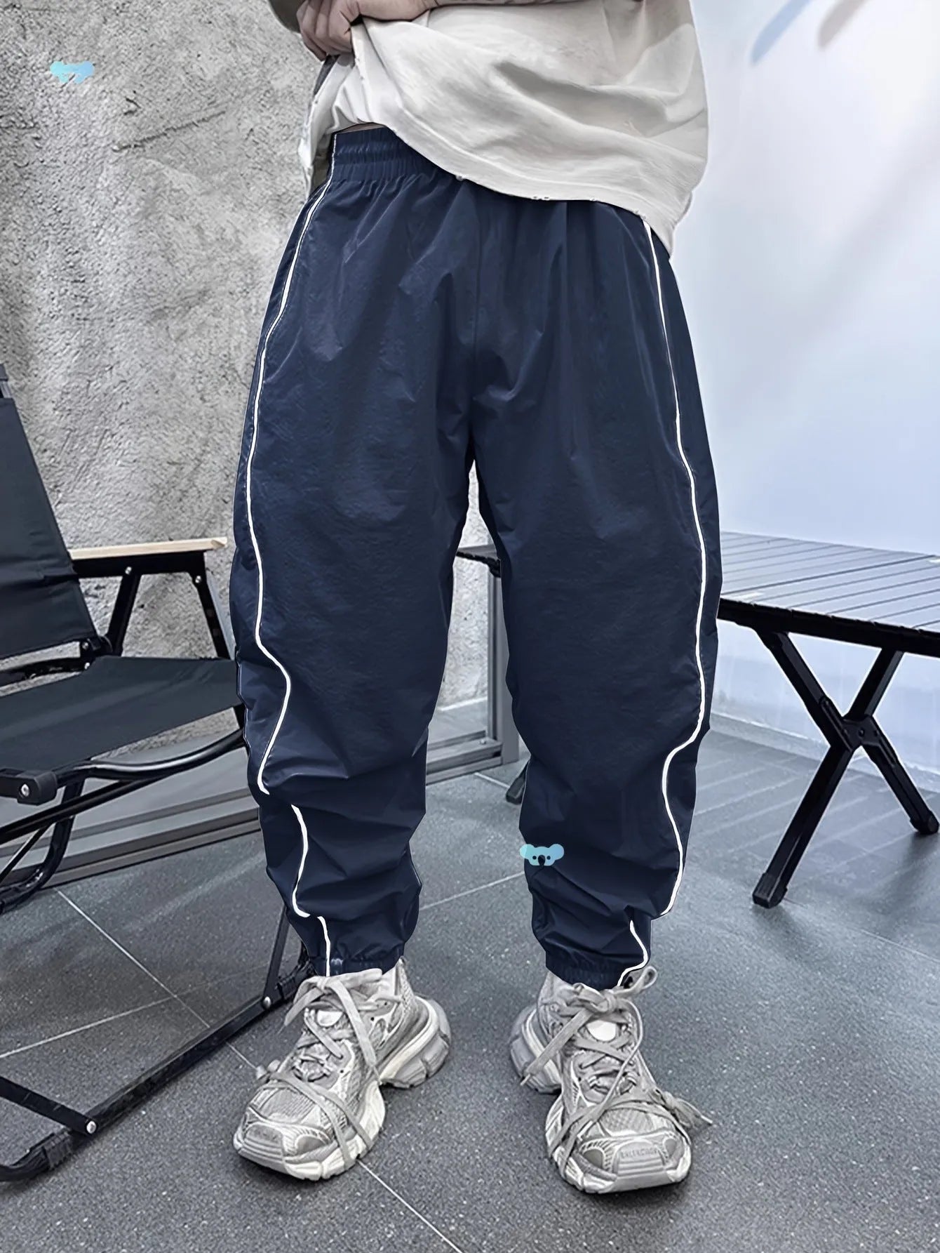 Man wearing loose, cropped blue bamboo fibre casual trousers.