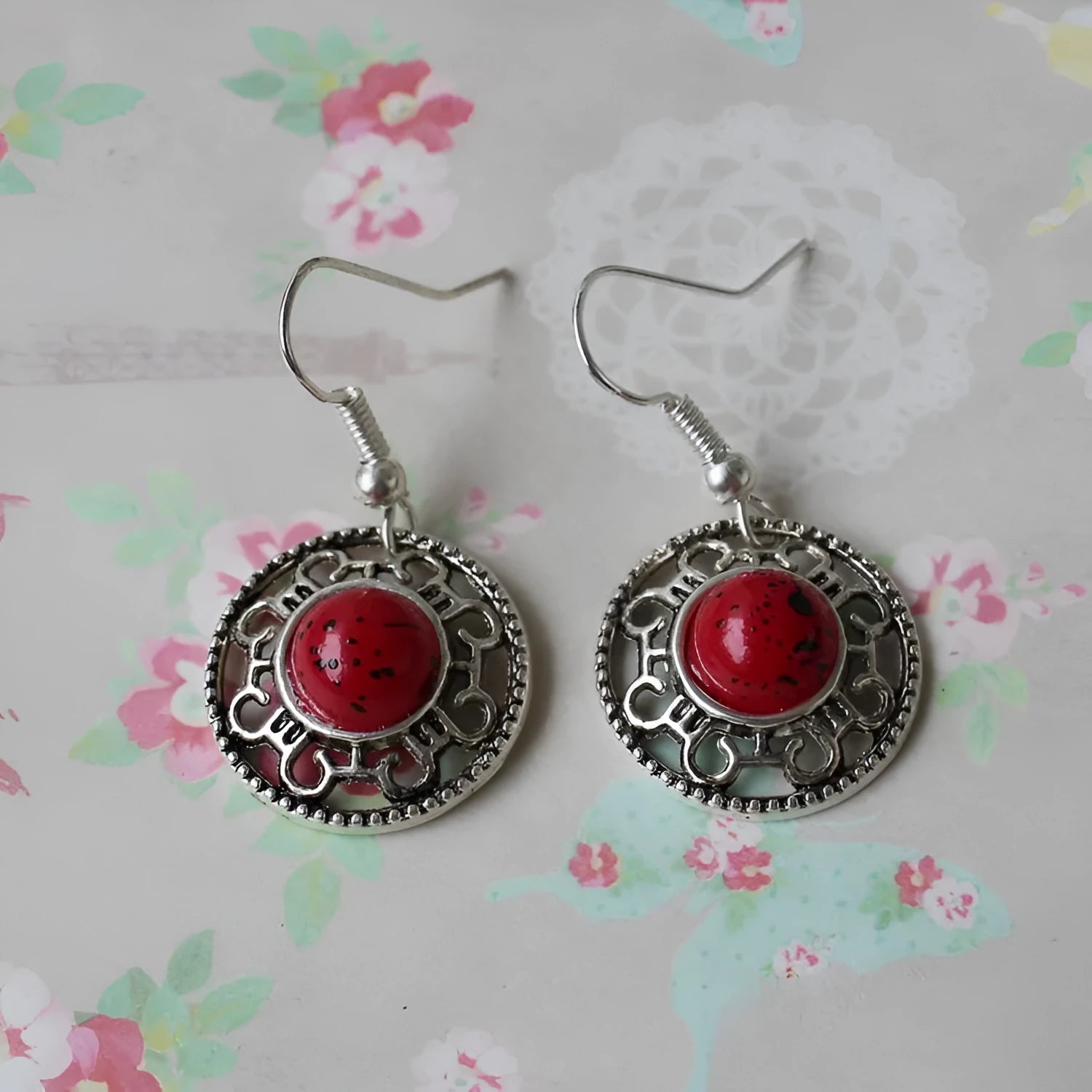 Handmade Miao ethnic style silver earrings with a blue turquoise flower disk and geometric patterns.