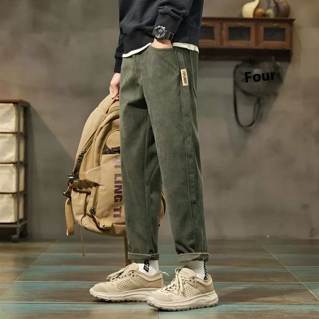 Men's army green corduroy casual trousers with a tapered straight-leg fit on a mid waist.