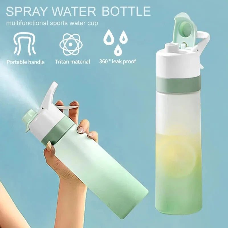 White 700ml plastic spray water bottle with a black handle strap and leakproof lid on a table.