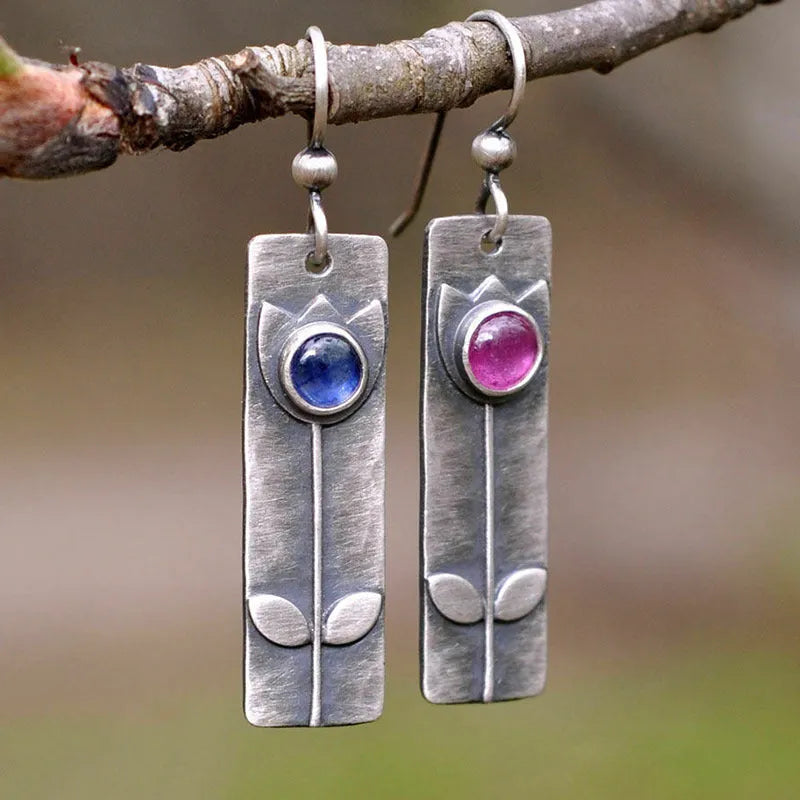 Antique finish geometric earrings with red sapphire stones and elliptical design elements