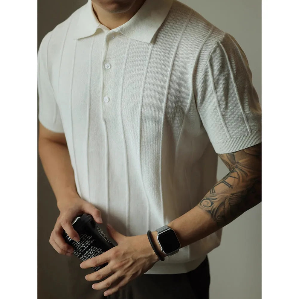 A man's loose-fit solid colour polyester pullover t-shirt on a hanger, shown in black and white colour options.