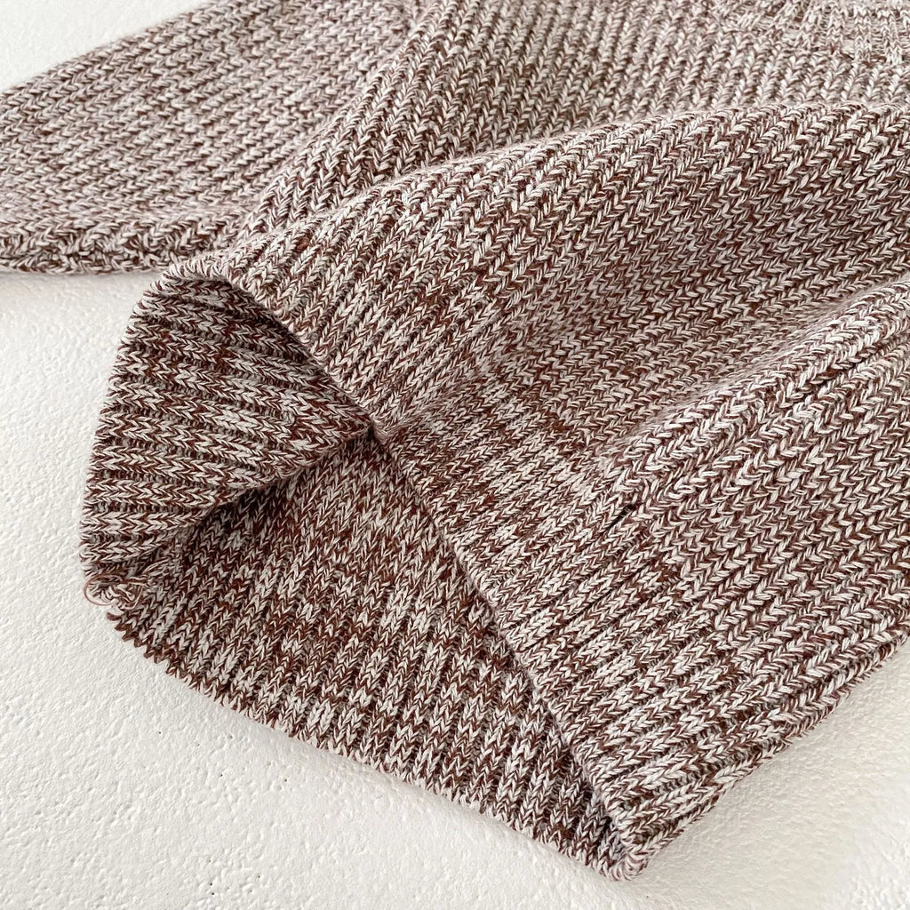 Dark brown knitted 3-piece set for infant girl with pullover blouse, pants, and fur ball hat