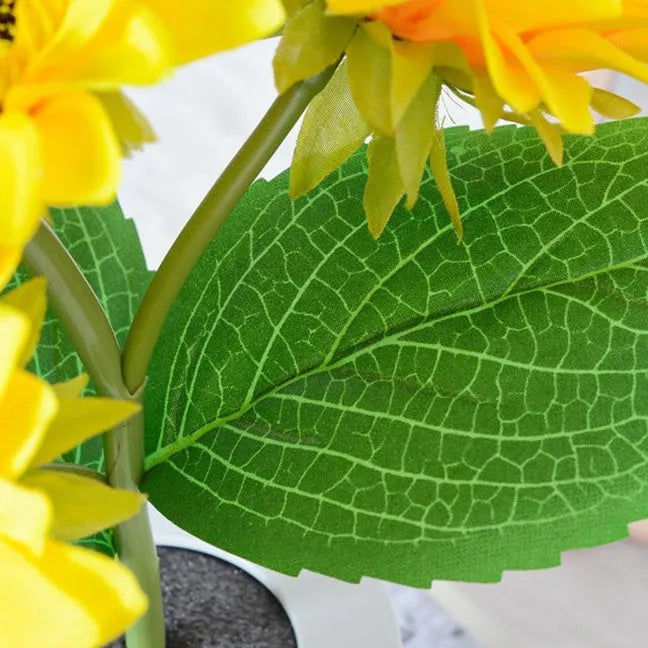 Sunflower LED night light with artificial flowers on wooden table