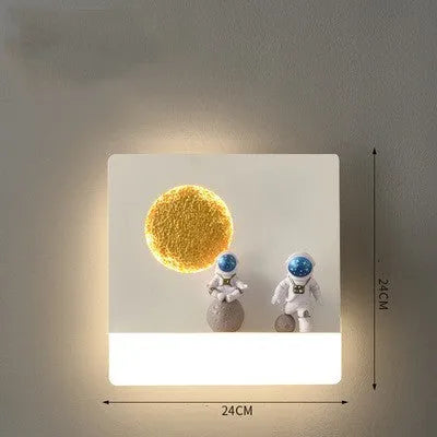 White astronaut-shaped wall lamp with a small shelf, mounted on a bedroom wall.