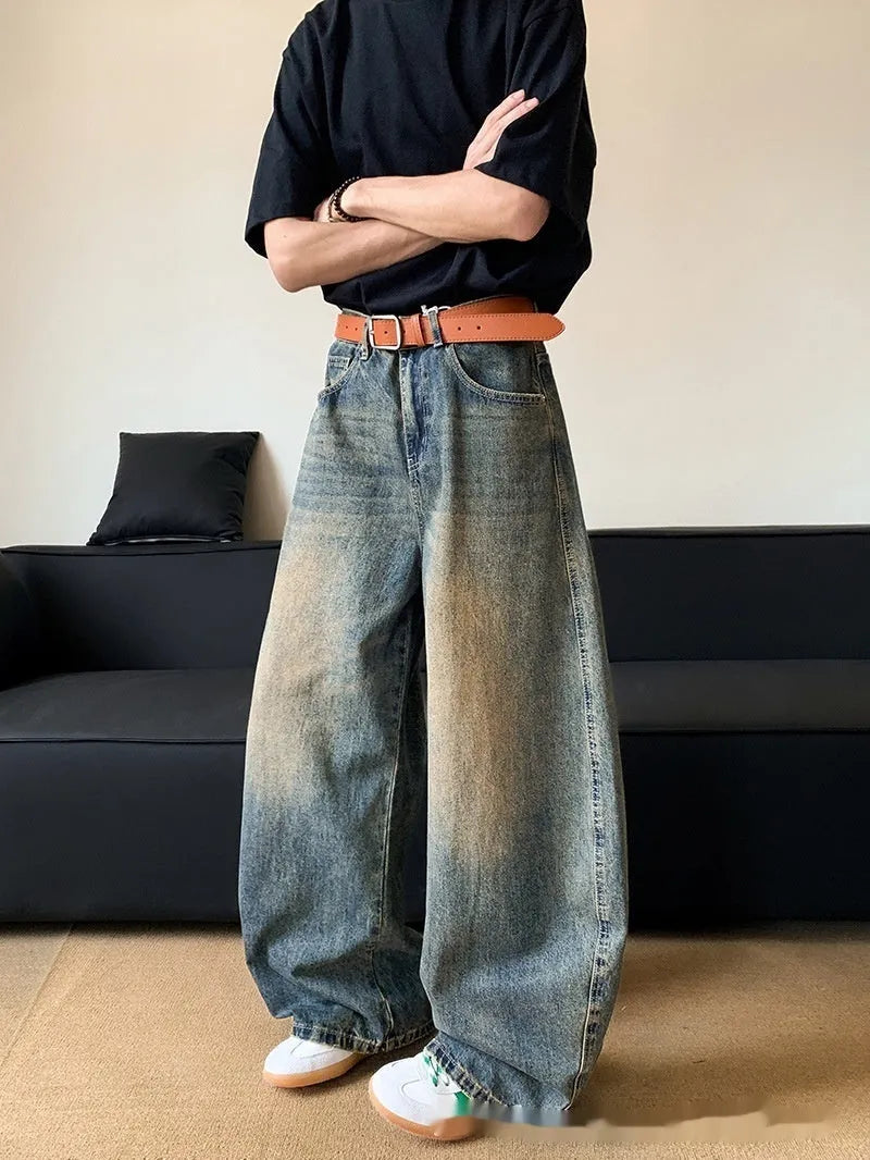 Man wearing retro blue distressed wide-leg denim jeans with machete detailing