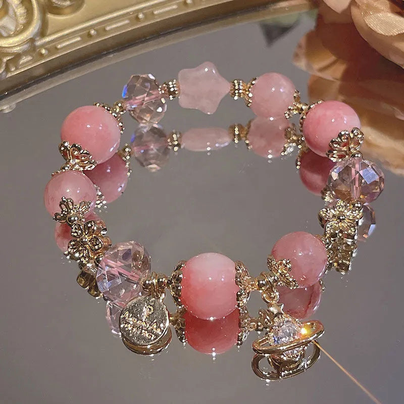 Galaxy-coloured alloy charm bracelet with snowflake, heart, and bow pendants.
