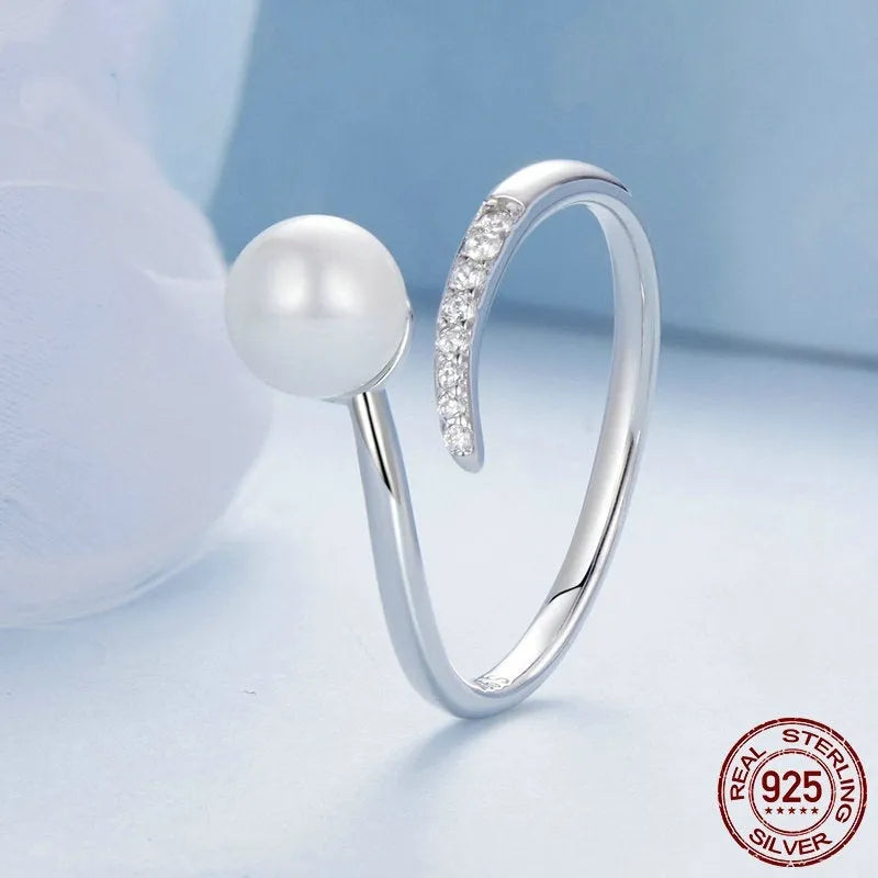 Women's sterling silver adjustable ring with shell pearls on open loop design