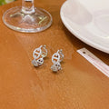 A pair of women's casual earrings with a thick gold-plated finish, shown in silver, gold, and rose gold colour options.
