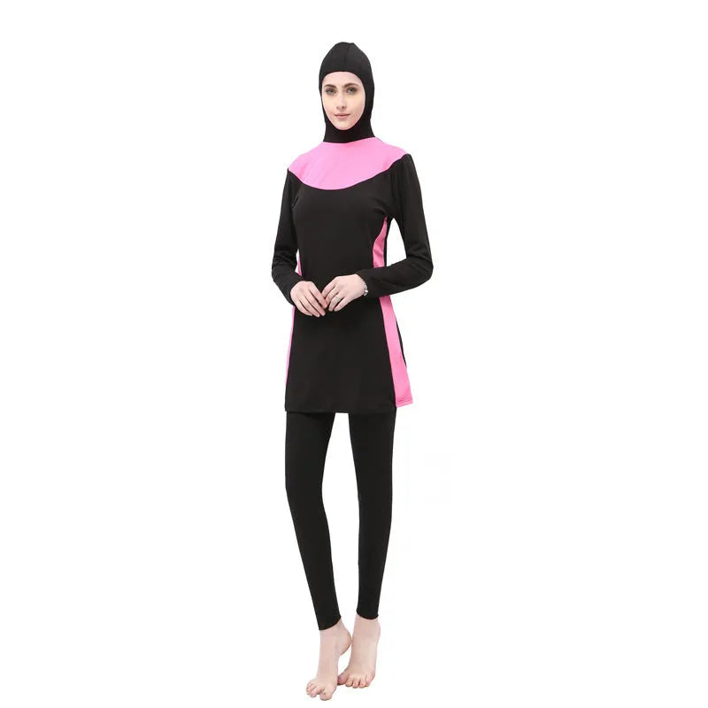 Women's black long sleeve hooded swimsuit top and pants set for swimming.