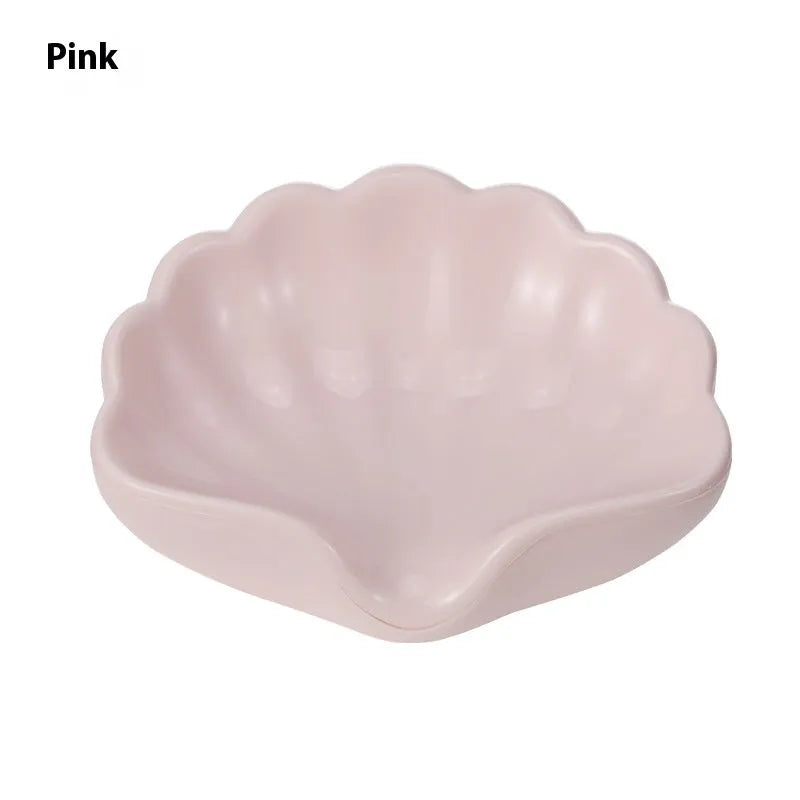 White or pink plastic shell-shaped soap dish for bathroom use