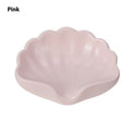 White or pink plastic shell-shaped soap dish for bathroom use