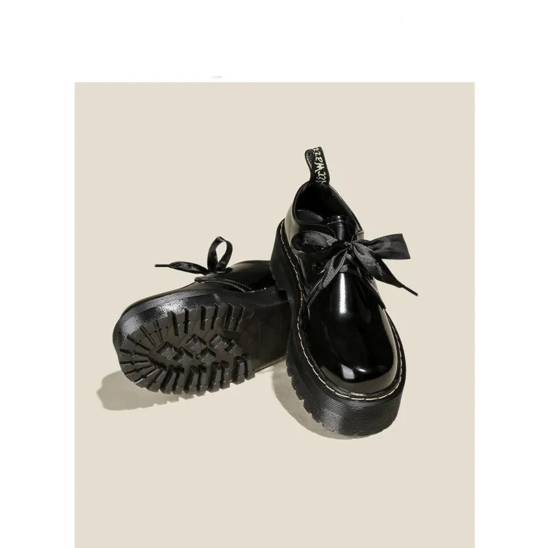 Women's thick-soled leather shoes with decorative ribbon cross-straps in black colour option