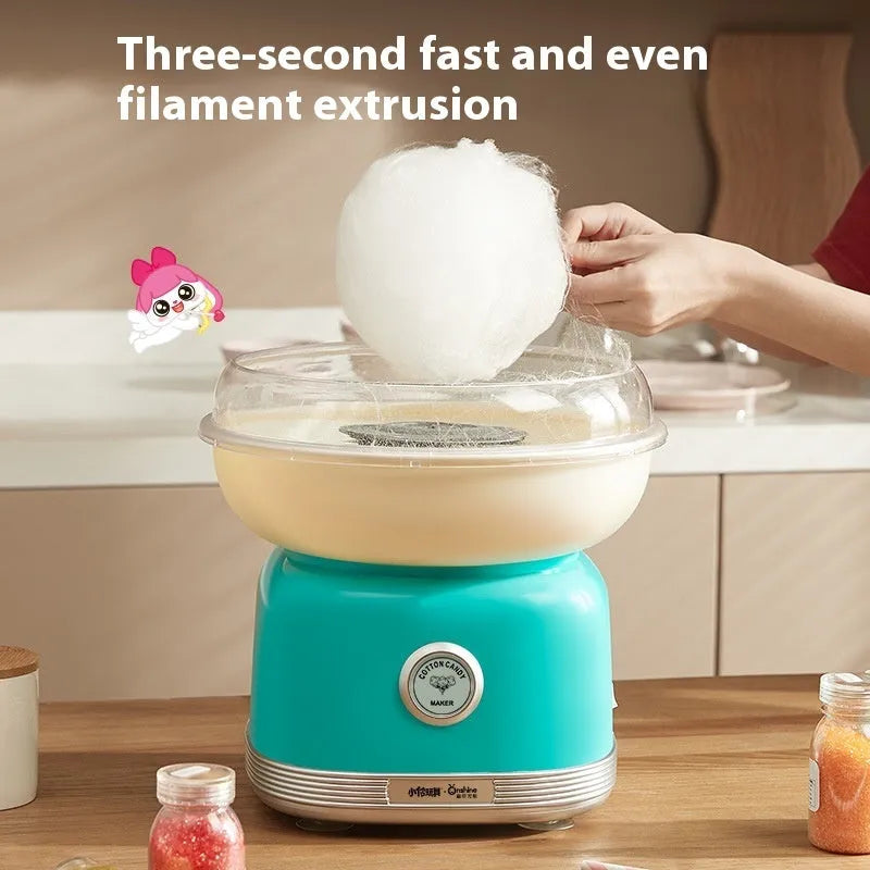 Pink mini electric cotton candy making machine with stainless steel body on a kitchen counter
