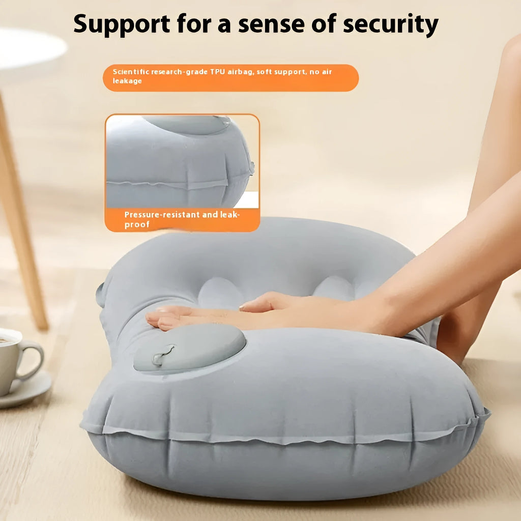 Inflatable travel pillow in grey flocking finish, shown inflated to its 45x30x13cm size with a soft texture.