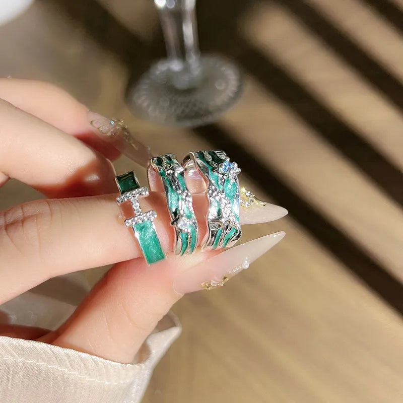 Mint green enamel asterism ring with copper base and eight-point star pattern on finger