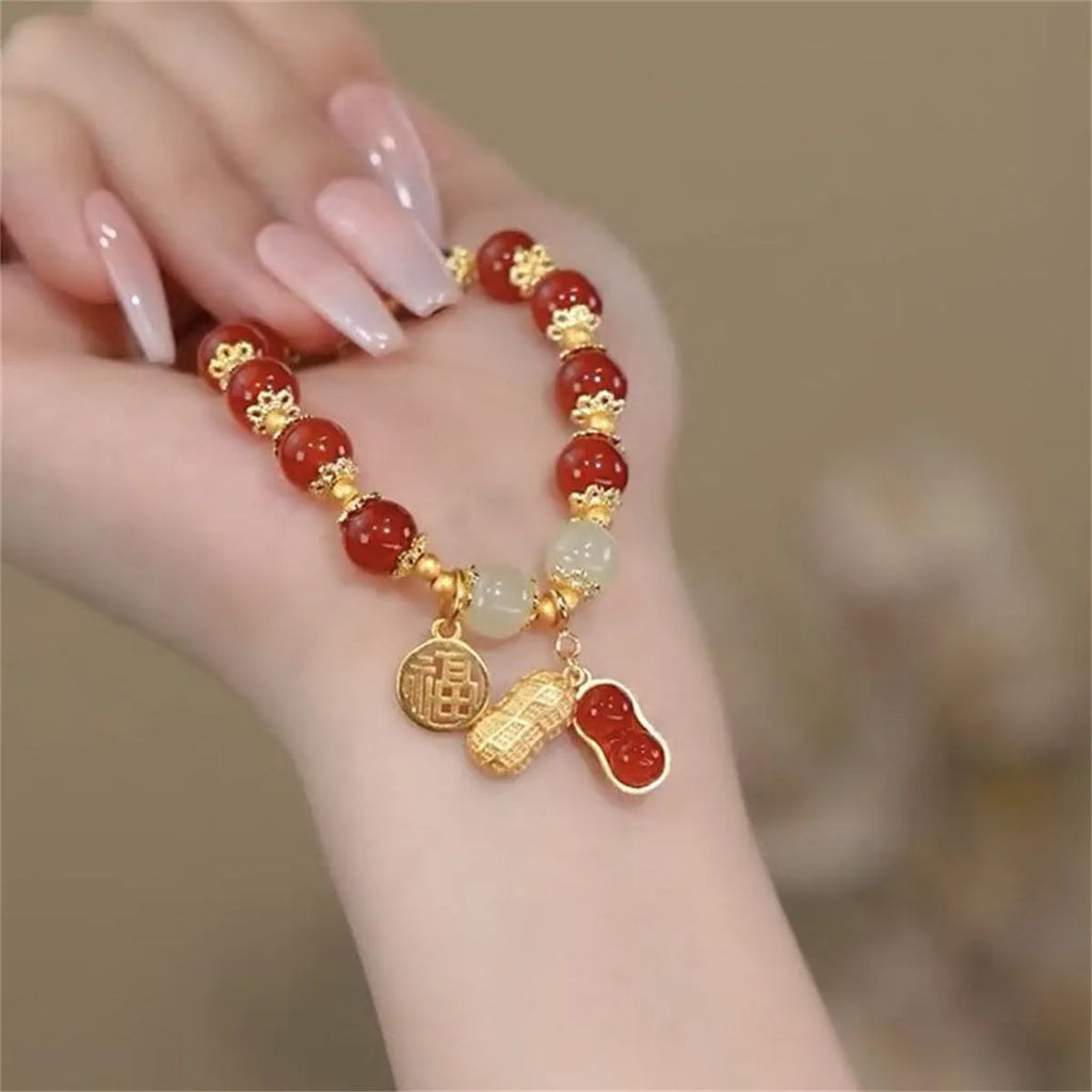 Simple women's bracelet with a peace buckle charm, coloured glass beads, and a small rabbit charm.