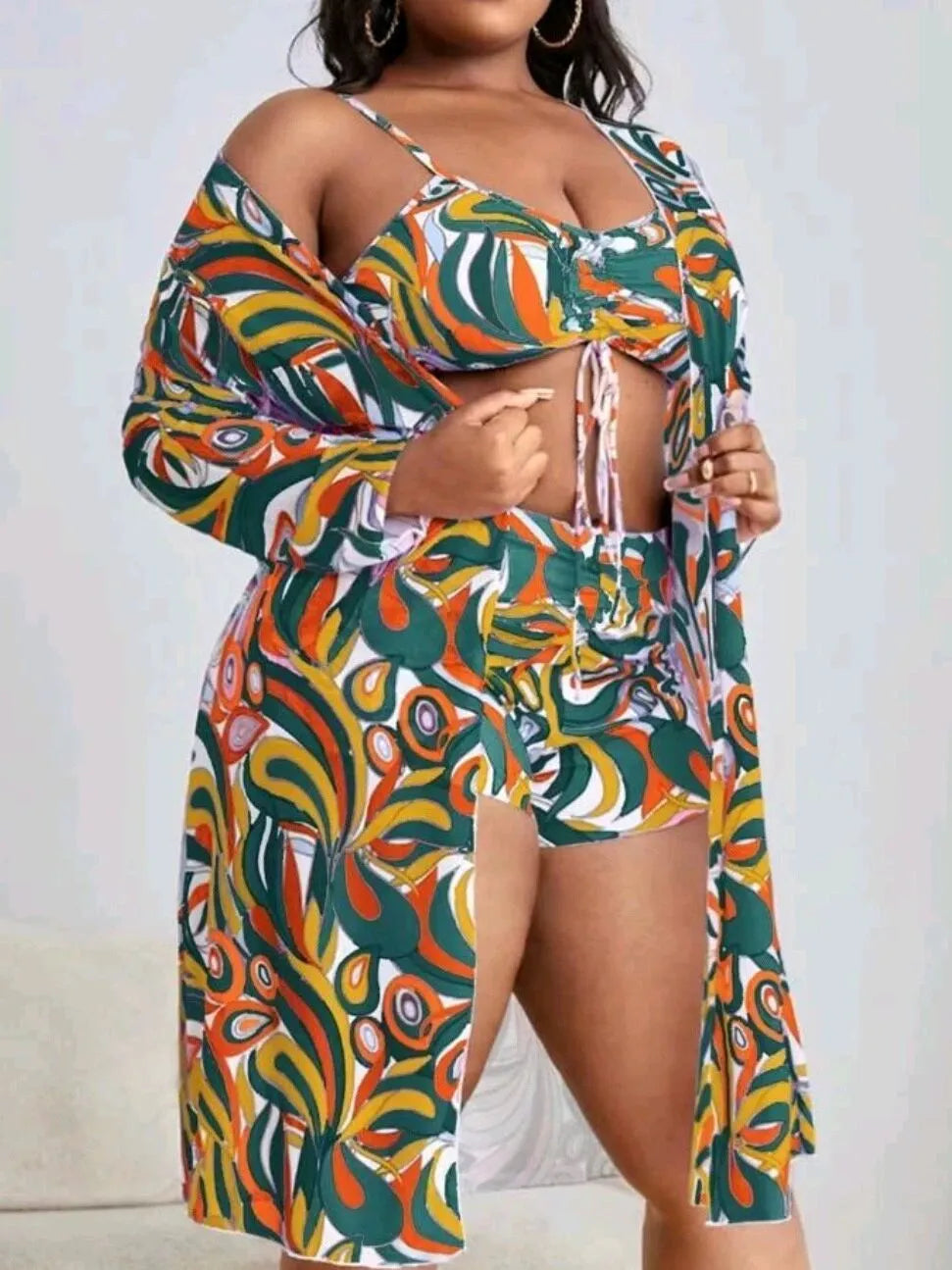 Women's floral patterned three-piece bikini set showing bra, shorts, and cardigan in plus sizes