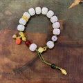 White jade Bodhi bracelet with lotus beads and a large pumpkin bead on an open rope.