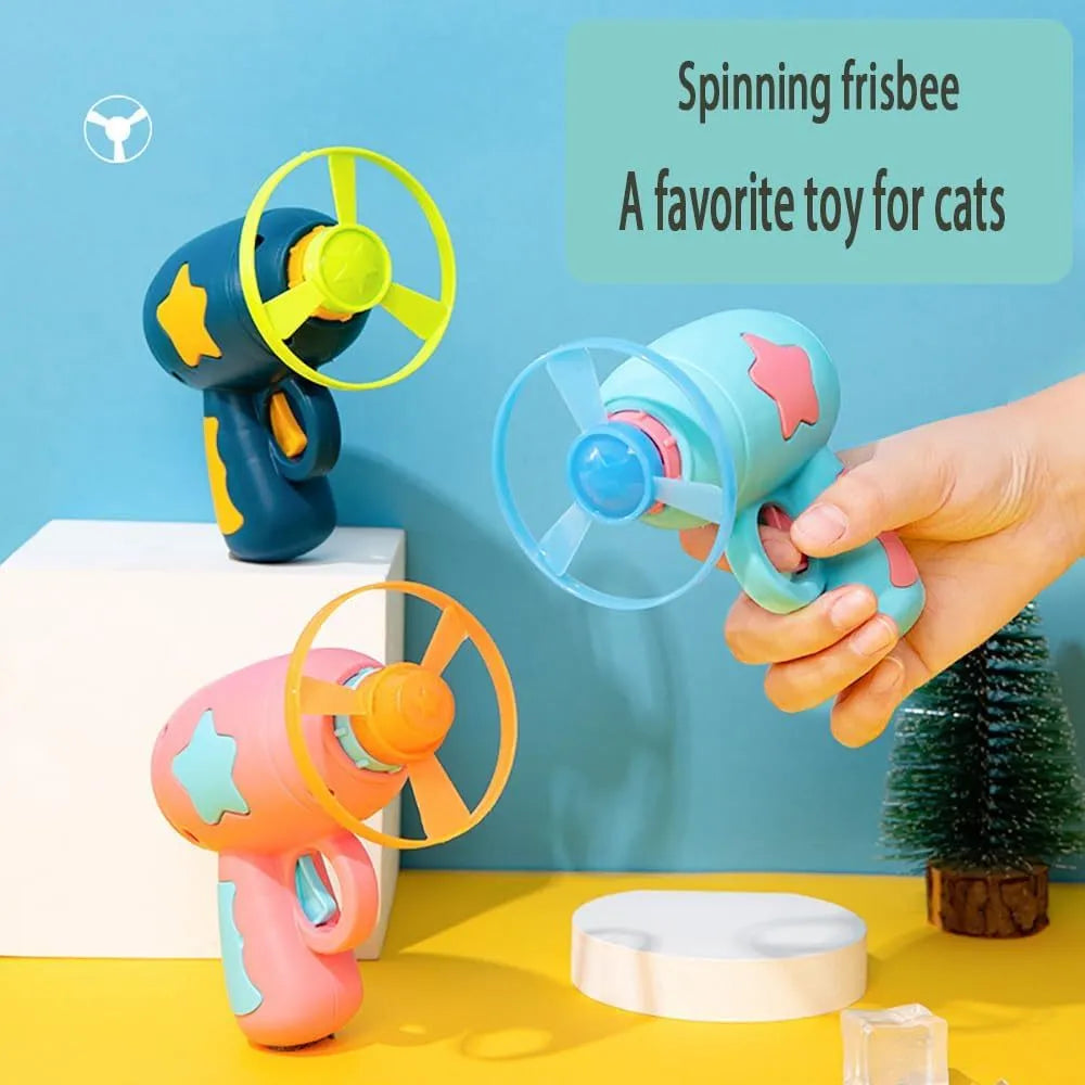 Interactive blue plastic cat toy gun with a spinning frisbee ready for launch.