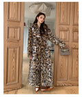 Faux fur coat with detachable collar in street fashion style showing long length and practical pockets