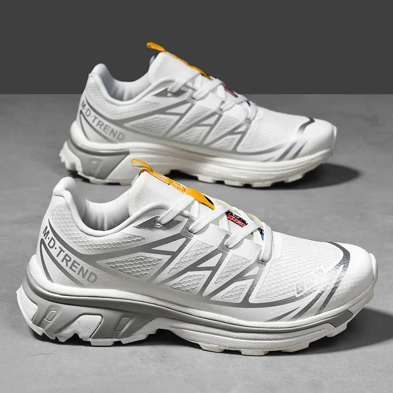 Low-top lace-up hiking shoes in artificial leather with a rubber sole and mesh lining.