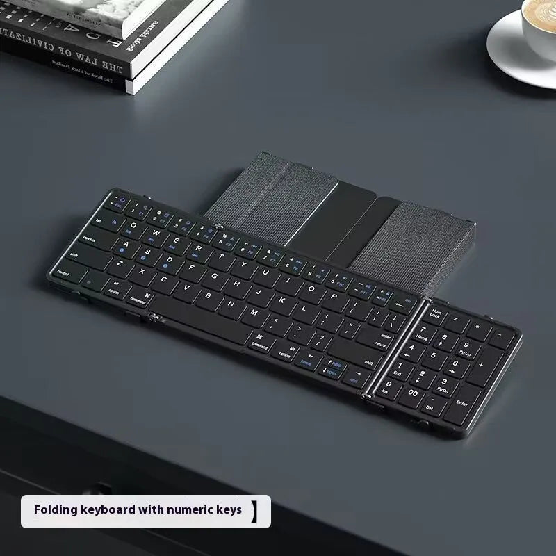 Black folding Bluetooth keyboard for mobile phones and tablets, shown next to a phone.