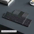 Black folding Bluetooth keyboard for mobile phones and tablets, shown next to a phone.
