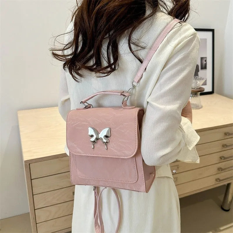 Women's preppy style PU backpack with hand-carry handle showing bow decoration and six colour options