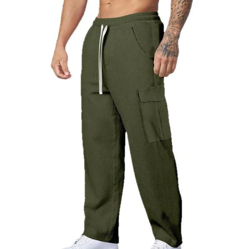 Men's navy blue corduroy cargo trousers with a straight loose leg and a drawstring waist, laid flat.