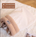 Brown semi-enclosed pet sleeping bag with plush lining on a wooden floor.