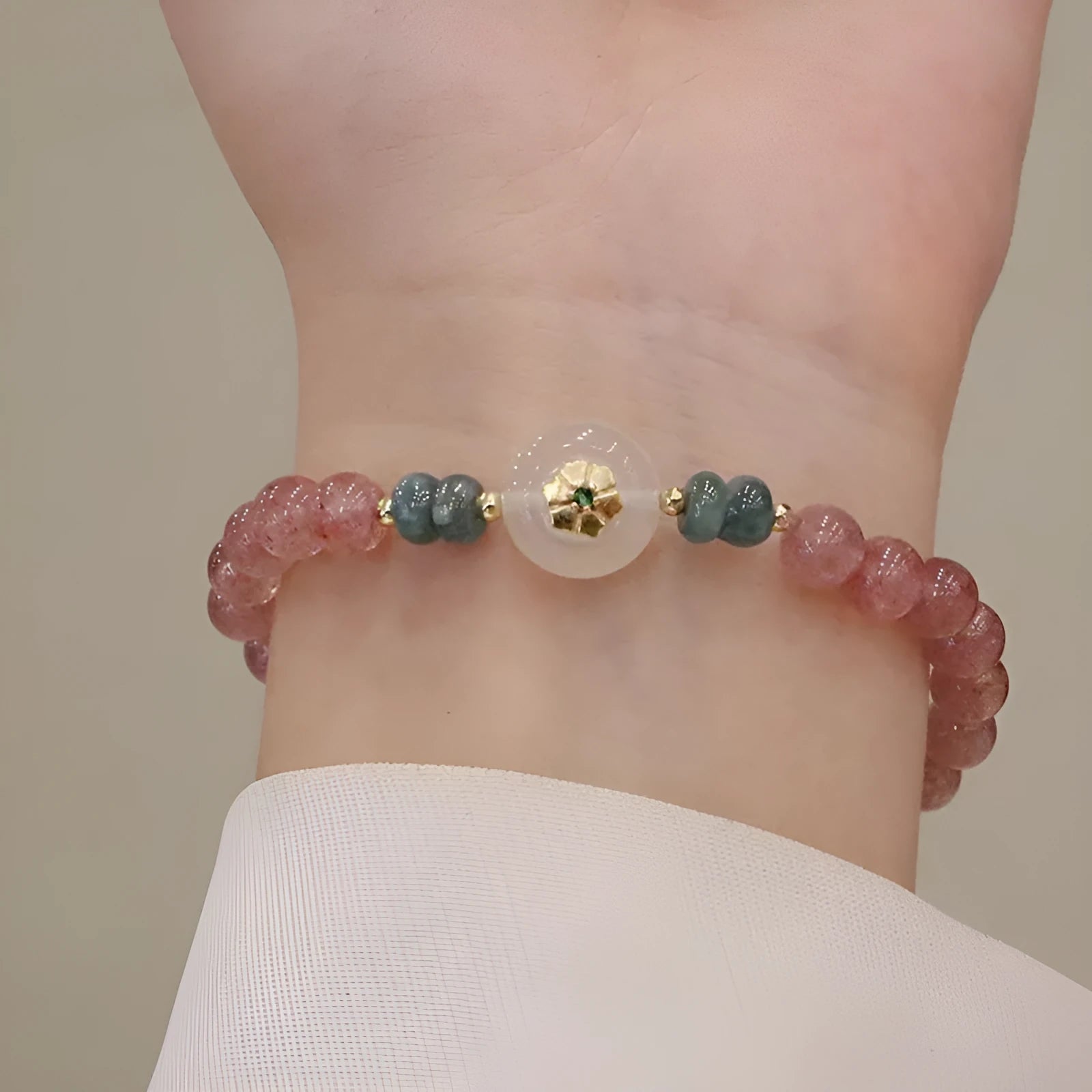 Women's strawberry quartz and blue water emerald bracelet with round jade pendant and geometric design