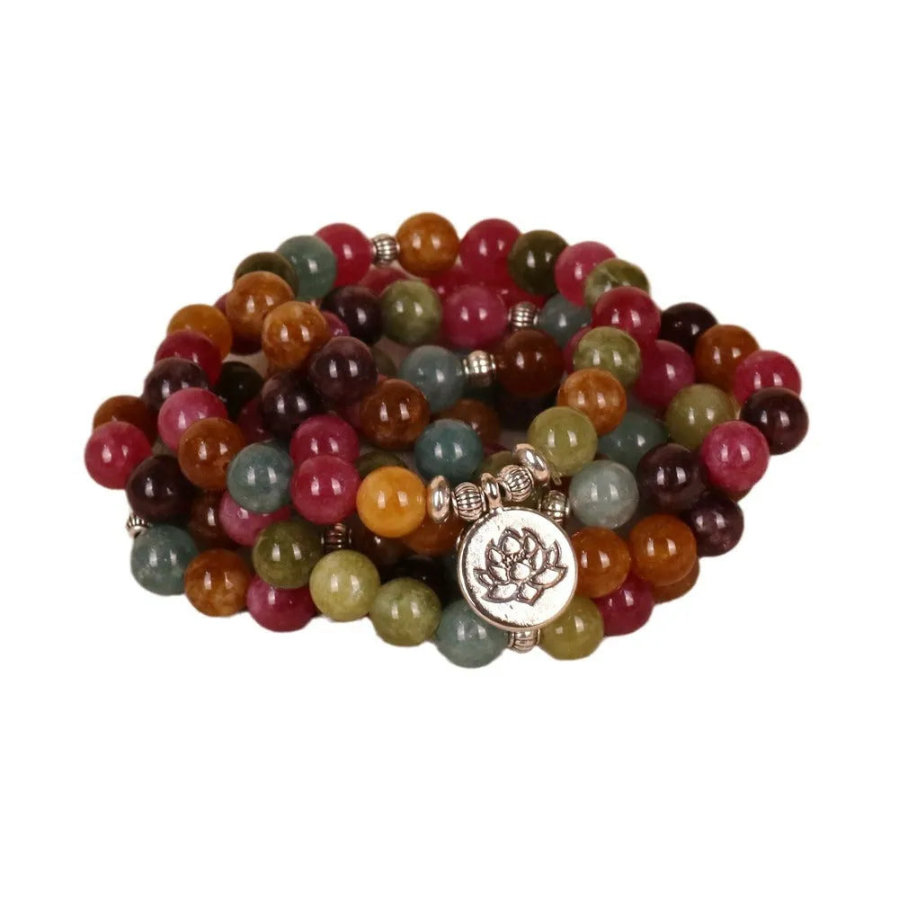 Close-up of a 108-bead alloy bracelet with a multi-layer lotus string design in a tourmaline colour.
