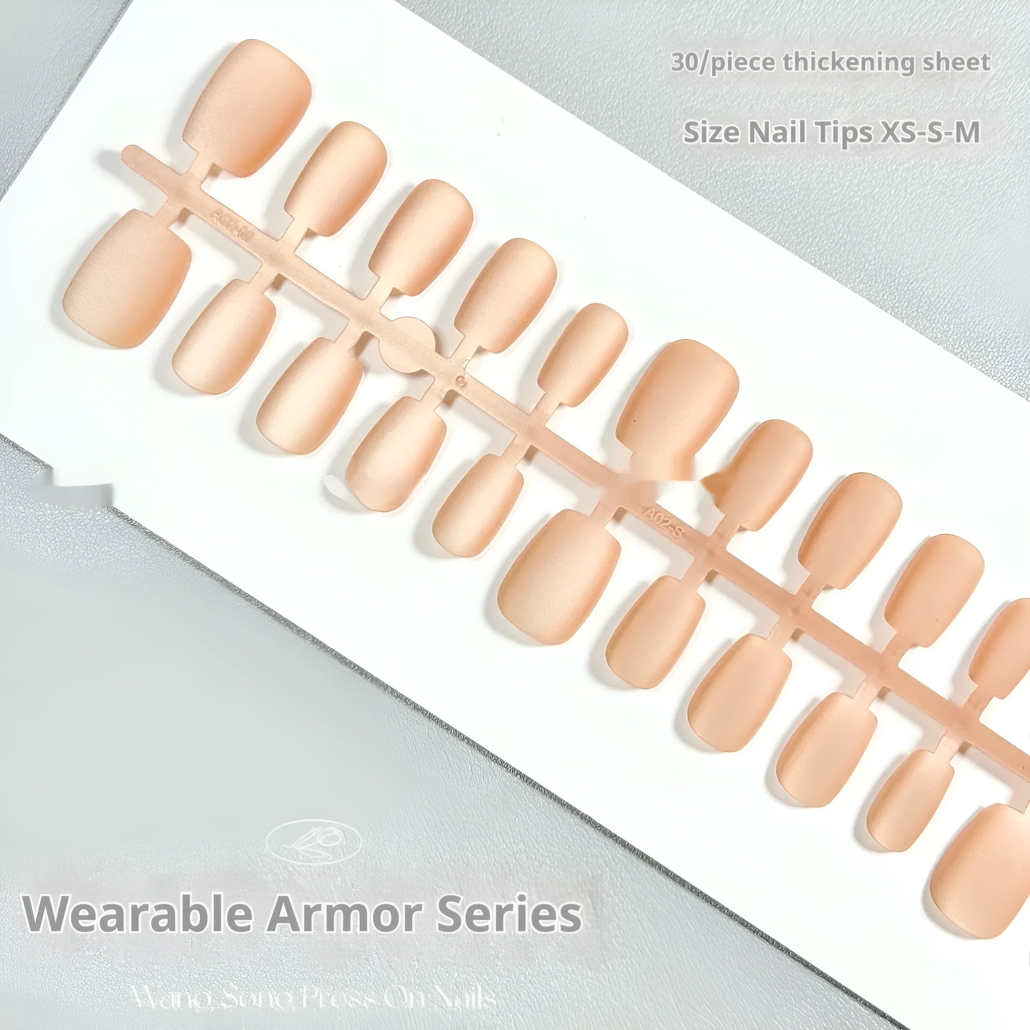 Set of velvet frosted Cat's Eye press-on nails showing Aurora armour design in short ladder sizes on a hand.