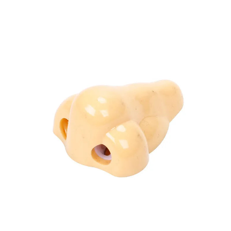 Flesh coloured plastic pencil sharpener with geometry shape on a white background.