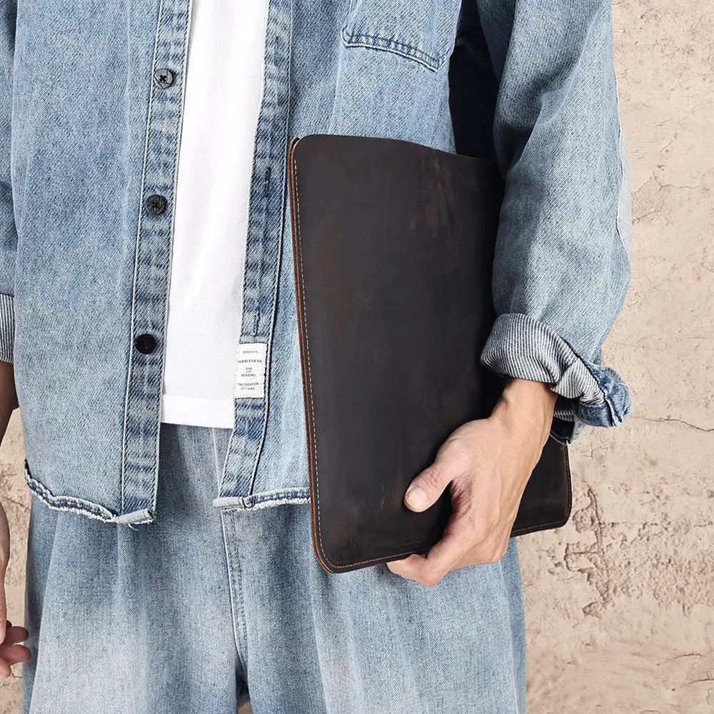 Brown horizontal computer liner bag made from cowhide leather showing laptop storage compartment